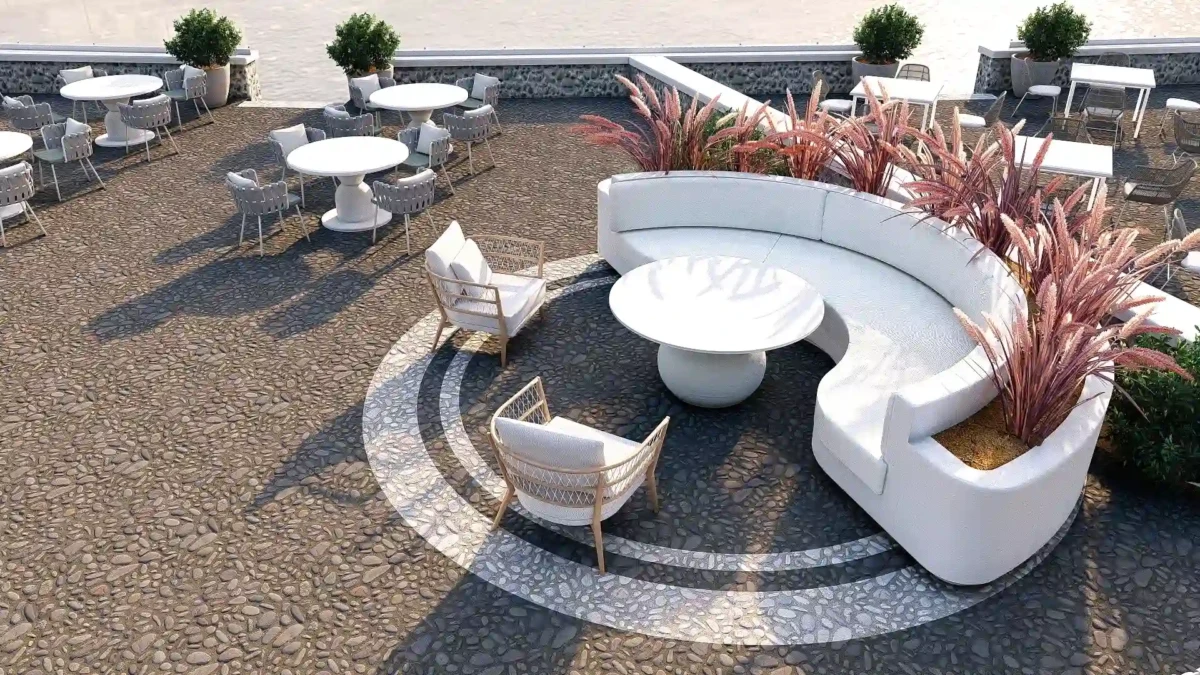 Υπαίθριο lounge σε wedding venue στη Σαντορίνη με καμπύλο ενσωματωμένο καθιστικό και διακοσμητική φύτευση